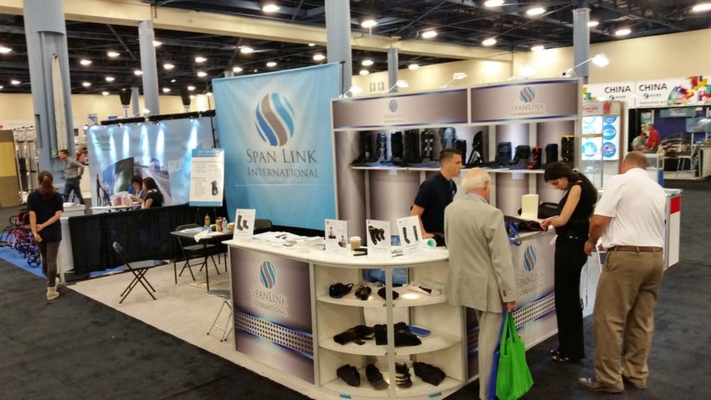 Trade show booth with innovative display of clothing in well-organized cabinets, illustrating how to display clothing at a trade show.