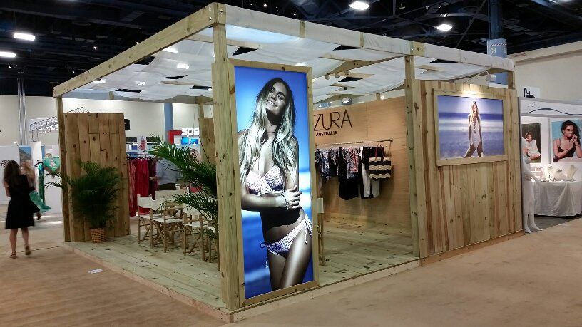 Cozy trade show booth demonstrating how to display clothing at a trade show, with women's underwear neatly arranged on racks and large displays.