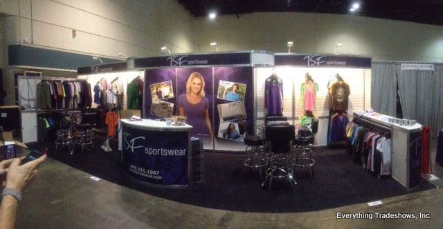 Trade show booth with an array of sports apparel on display racks, illustrating how to display clothing at a trade show effectively.